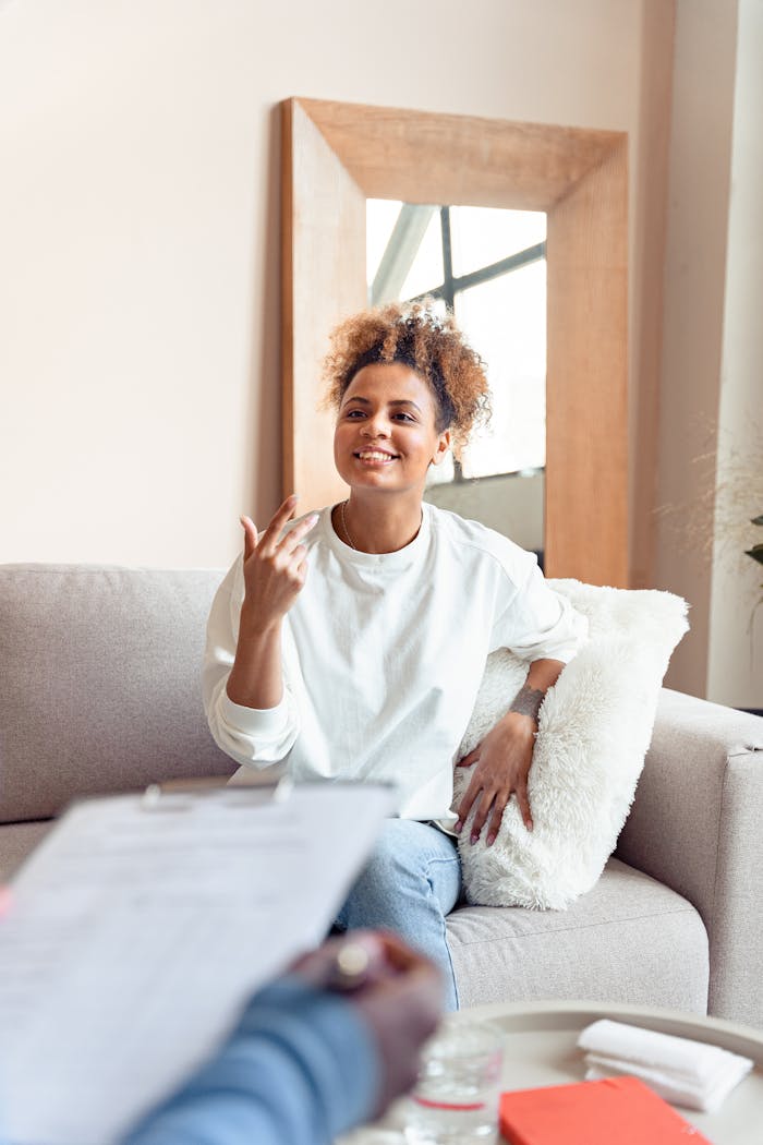 The Art of Drawing Readers In: Your attractive post title goes here Smiling woman in a therapy session on a comfortable sofa.